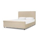 Curved footboard corner in cream slipcover fabric with subtle rolled edge detail