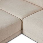Close-up showing seams where chaise and sofa seat cushions meet on sectional