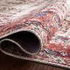 Close-up side view of the rug folded to show thickness and flexible polyester material.