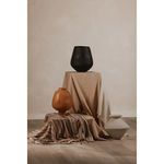 Voss vessel staged with two differently shaped vases and layered neutral fabrics