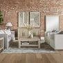 Siena sofa styled in living room with matching wood furniture and brick wall background