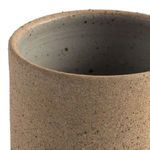 Close-up of natural speckled clay mug rim and interior texture