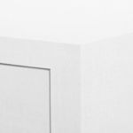 Close-up of textured white washed lacquered linen finish on table corner and side edge