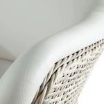 Close-up of white vinyl armrest texture and wicker weave details