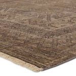 Close-up showing dense weave and fringed edge with textured brown and tan pattern