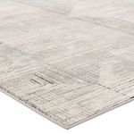 Close-up angle showing detailed texture and high-low pile of gray and cream geometric pattern
