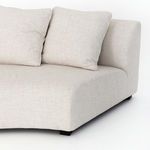 Close-up on curved arm and two square cushions highlighting linen-blend upholstery texture