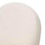 Close-up of rounded top edge of cream fabric backrest exposing fine fabric weave