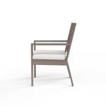 Side profile highlighting chair’s angled backrest and armrest design