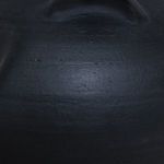 Close-up showing fine textured surface characteristic of hand-thrown black terracotta