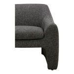 Close-up on Barrow chair right armrest showing boucle fabric and curved silhouette