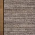 Close-up of Thorne Stone Rug corner on wood floor highlighting weave texture and subtle color variations
