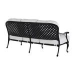 Three-quarter rear angle showing lattice backrest and cushioned seating on aluminum sofa