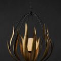 Endymion Chandelier shown with dark background emphasizing wire cage and brass leaves