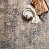 Anastasia Mist Blue Rug styled with decorative plates and natural elements on top