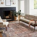 Jules rug featured in bright living room with beige sofa, cream accent chair, and natural light from large windows