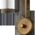Close-up of gold round dimmer switch knob and bottom edge of smoke glass shade