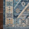 Close-up of the rug’s border detail showing woven geometric patterns on dark wood floor