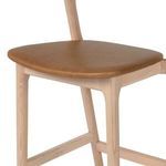 Detail close-up of Amare Stool's butterscotch leather seat and wood frame