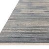 Low-angle view showing rug’s fringed edge and its power-loomed polyester texture