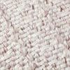 Close-up of the woven blush and natural textured fabric of the Devon pillow showing detailed yarn pattern