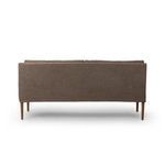 Rear view showing smooth linen backrest and narrow amber oak legs