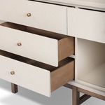 Close-up showing two plywood drawers opened partially, highlighting wood interior and brass knobs
