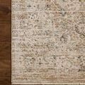 Detailed flat-lay corner showing faded pattern and soft fringe edging on hardwood floor