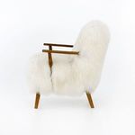 Side profile showing thick fur backrest and seat with slender drifted oak legs and arms