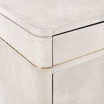Detailed view of Andre cabinet gold trim separating drawer from doors and rounded edges