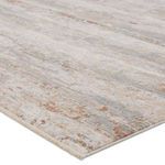 Close-up angled view highlighting rug’s high-low pile and color blending with cream fringe