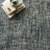 Close-up top view of rug with books and eucalyptus leaves arranged on surface
