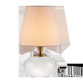 Diantha Table Lamp with polished optic crystal orb base, antique brass neck, and white tapered fabric shade
