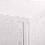 Close-up of top corner showing smooth lacquered finish and framed grasscloth panel