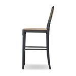Side profile highlighting slightly curved rear legs and paper cord back on black ash stool