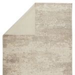 Back side of rug folded over showing smooth, plain weaving on reverse