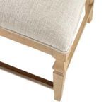 Close-up of textured Slipaway Sand fabric upholstery and wood frame corner