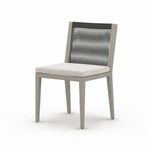 Three-quarter angle focusing on chair's texture and rope detailing with stone grey cushion