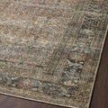 Angled view of rug edge showing border pattern and pile texture against hardwood flooring
