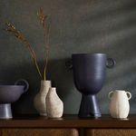 Cascada Large Vase displayed on shelf in room with other pottery in dark and light finishes