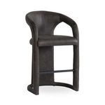 Counter stool with distressed dark leather upholstery, curved backrest, integrated armrests, and black metal footrest
