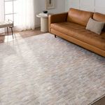 Luray rug styled in living room with tan sofa, side table, and natural light through window