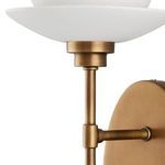 Close-up of the brass stem and the largest bone china cup with smooth matte texture