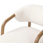 View from rear-left corner showing tapered oak legs and thick ivory cushioned backrest