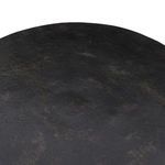 Close-up focusing on the textured tabletop surface showing uneven bronze tones