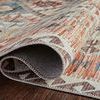 Close-up of rolled edge revealing tight weave and backing of Zion rug on dark wood floor