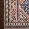 Tight close-up of corner showing crisp patterns, pile texture, and color contrast on wooden floor