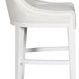 Side profile of Cove Stool emphasizing the gentle curve of the backrest and armrest detailing in white fabric