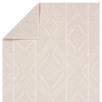 Rug folded at one corner revealing flat backing and diamond pattern on top
