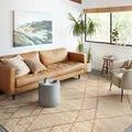 Bodhi Ivory rug styled in modern living room with leather sofa and large window